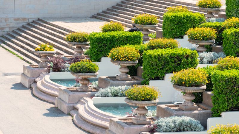 A beautifully designed garden featuring terraced planters and a stone staircase, ideal for landscaping inspiration. — 10 Meth